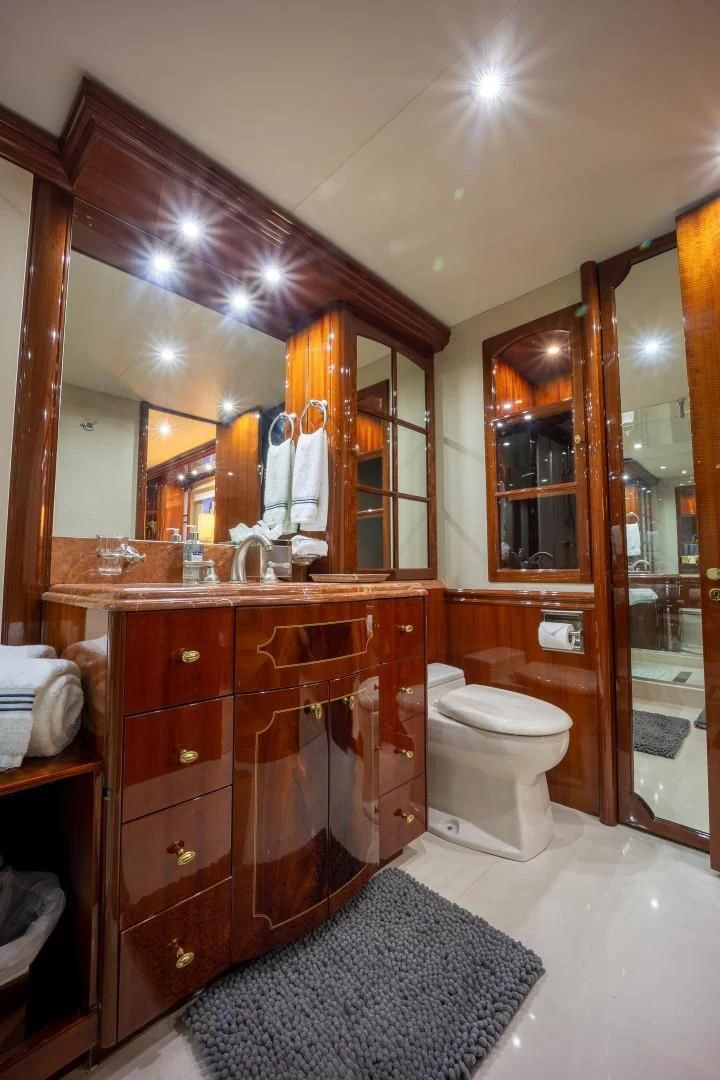 a bathroom with a large mirror aboard CENTER RING Yacht for Sale