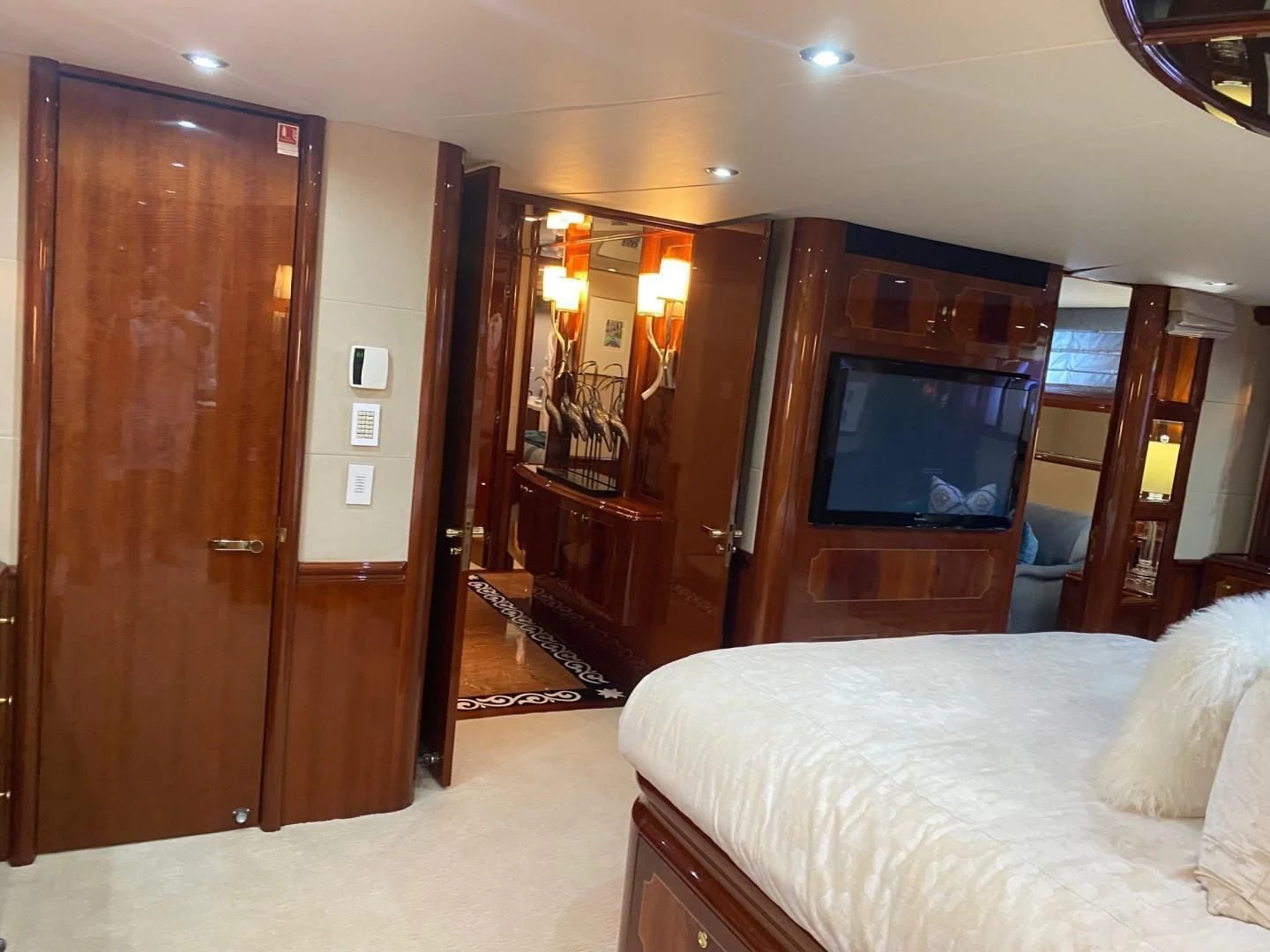 a hotel room with a tv and bed aboard CENTER RING Yacht for Sale