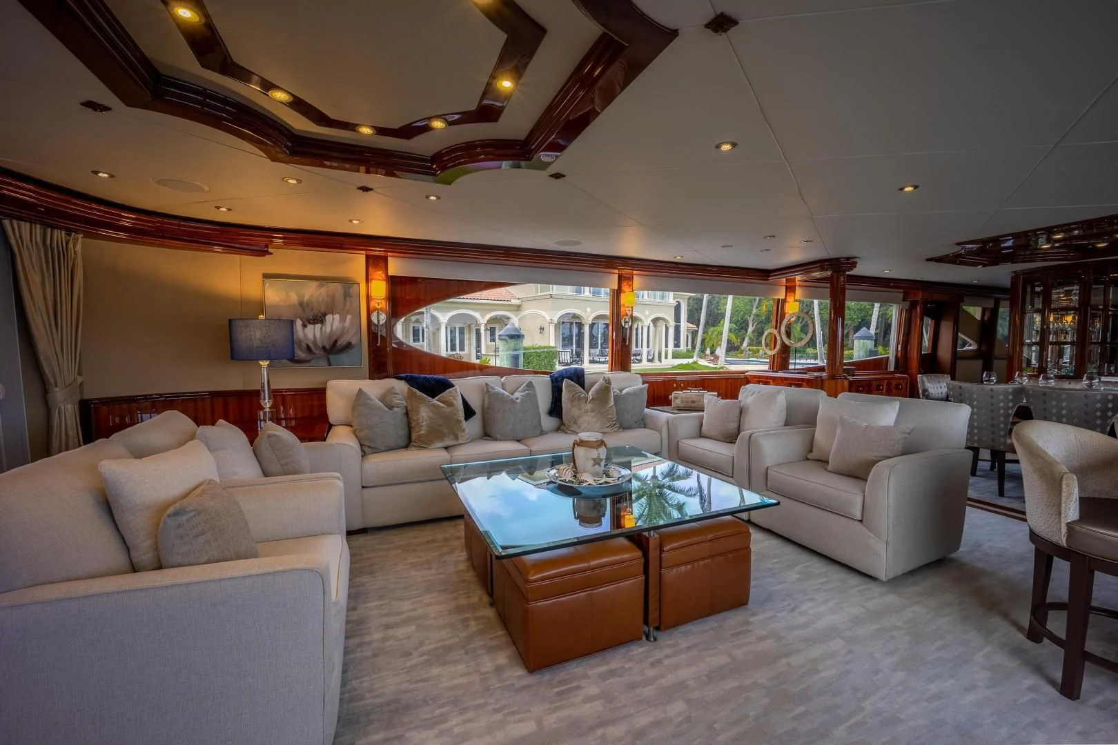 a living room with a large glass table and a large window aboard CENTER RING Yacht for Sale