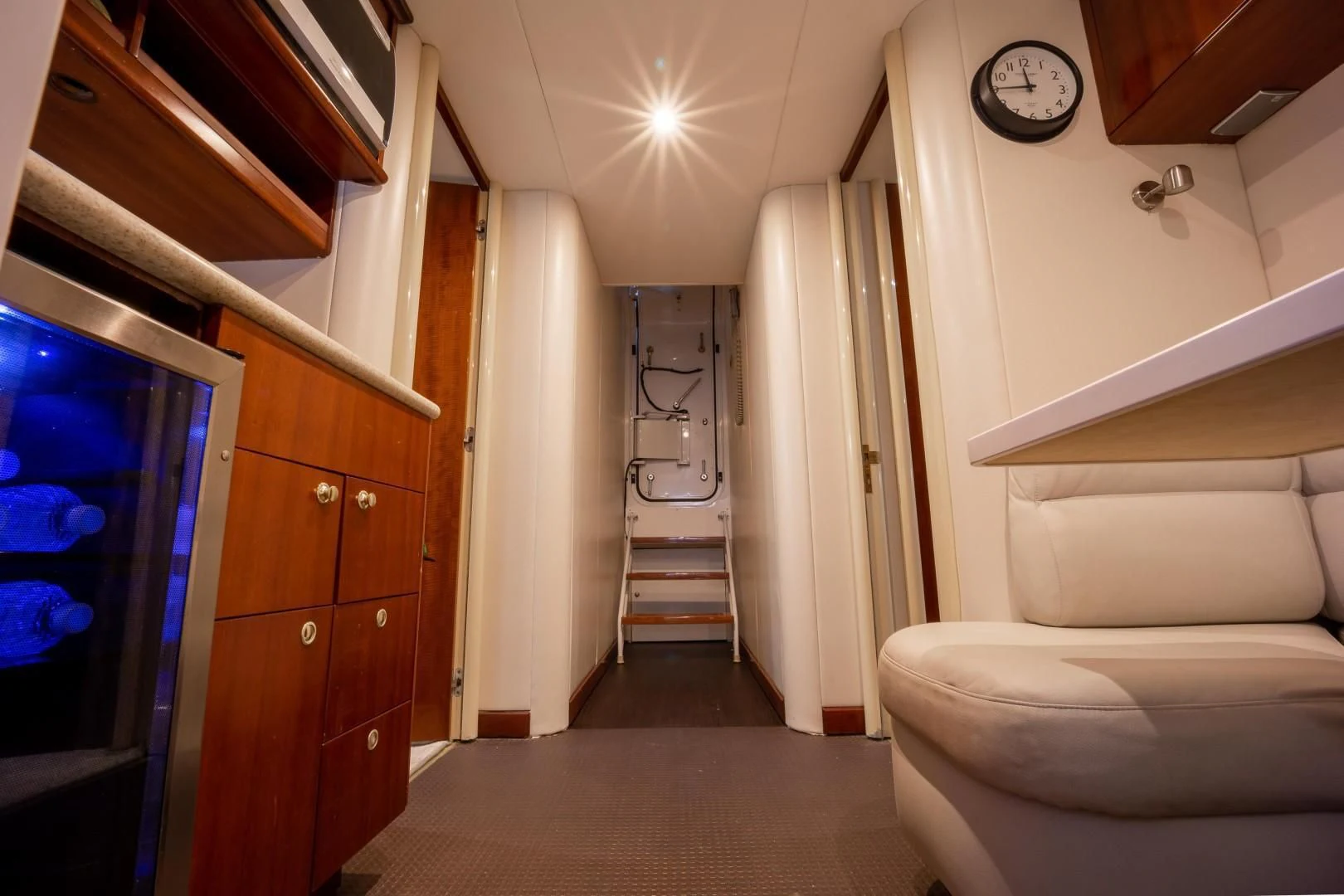 a room with a staircase and a clock on the wall aboard CENTER RING Yacht for Sale