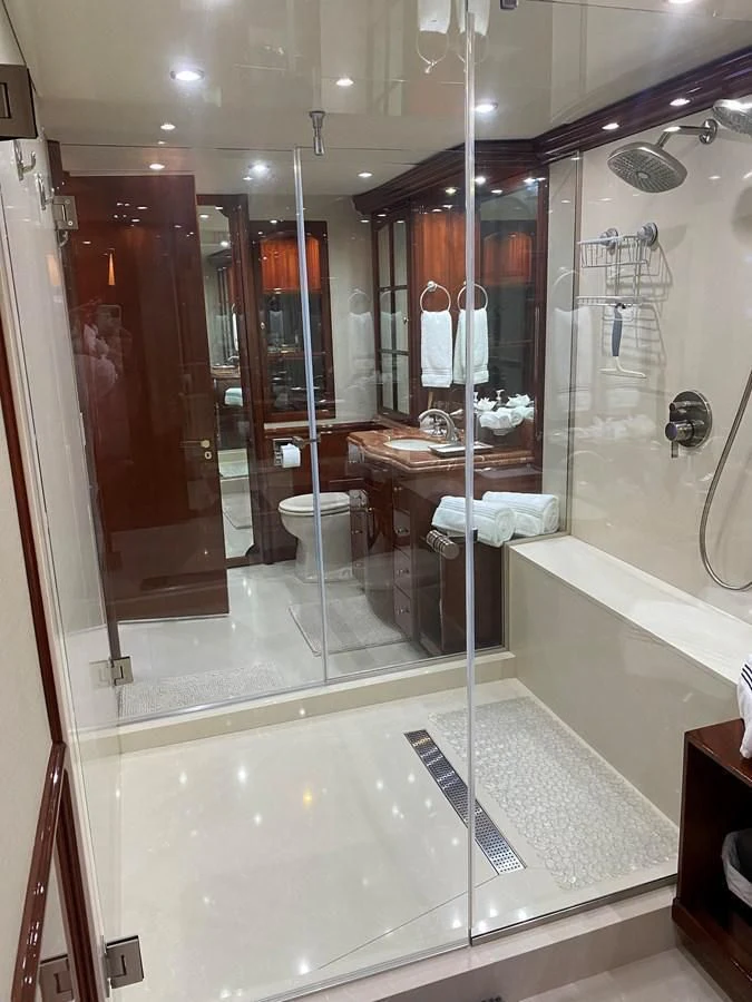 a bathroom with a glass shower aboard CENTER RING Yacht for Sale