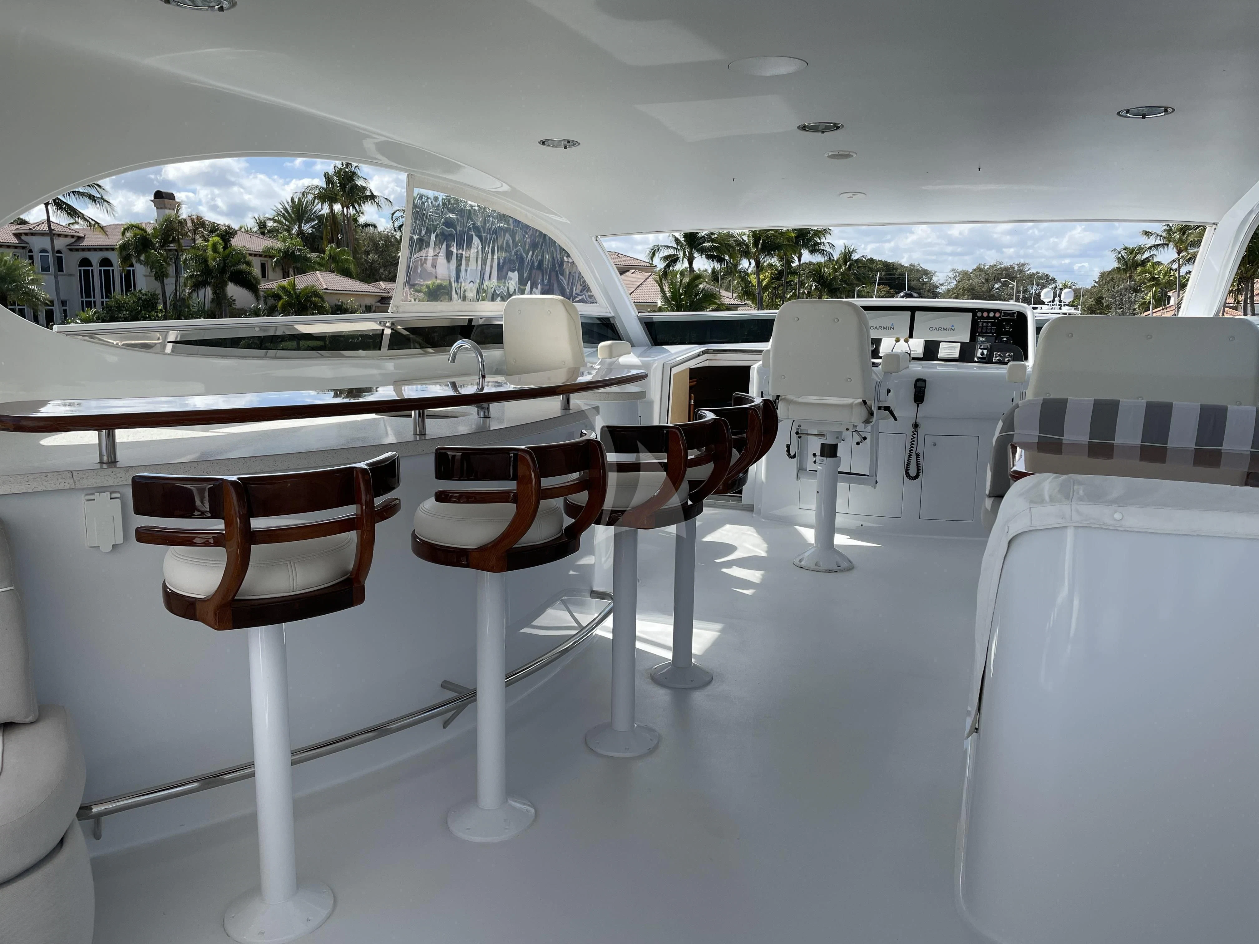 a room with white chairs and tables aboard CENTER RING Yacht for Sale