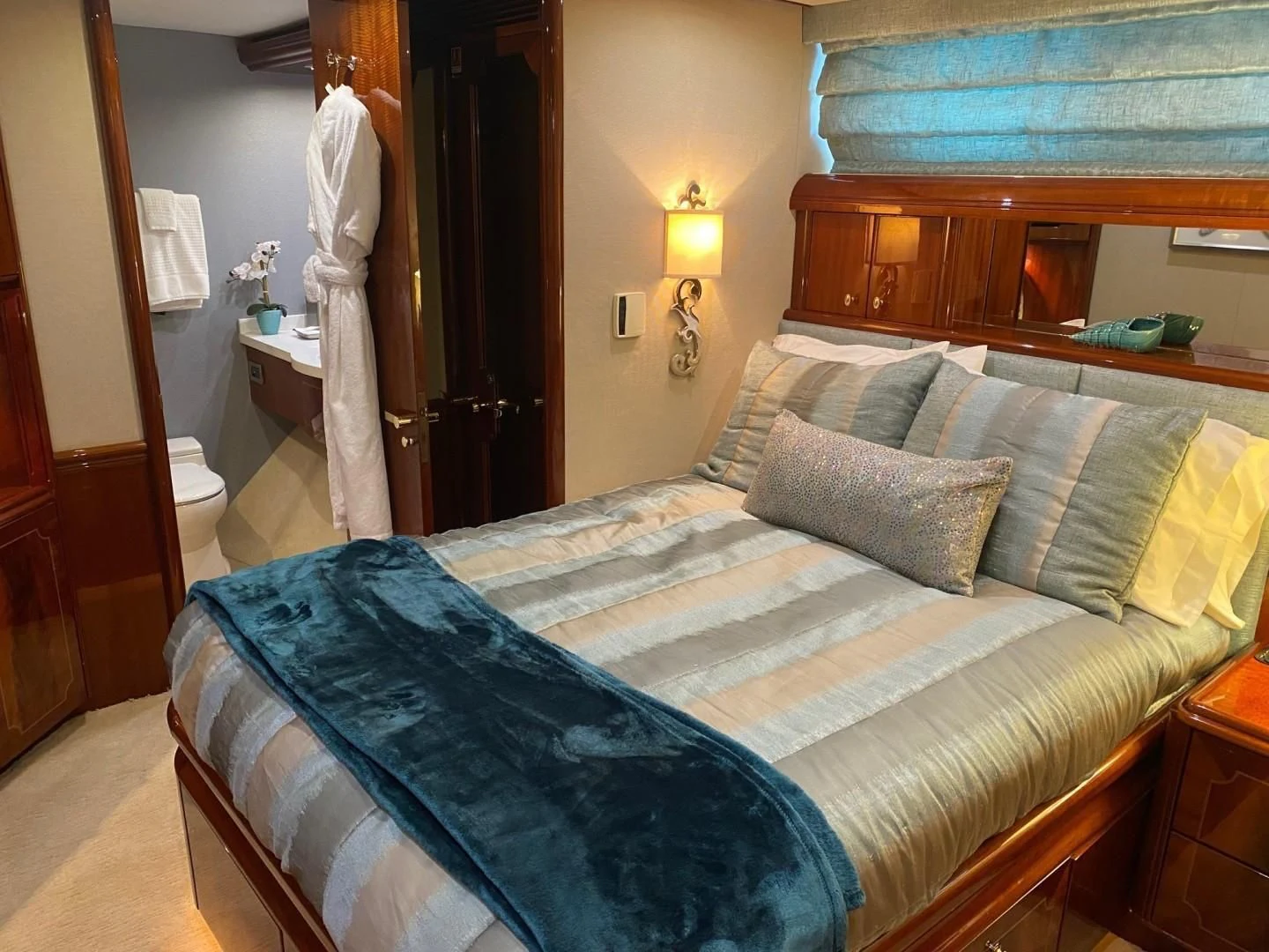 a bed with blue sheets aboard CENTER RING Yacht for Sale
