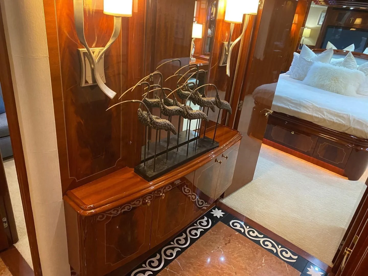 a wooden piano with a chandelier aboard CENTER RING Yacht for Sale