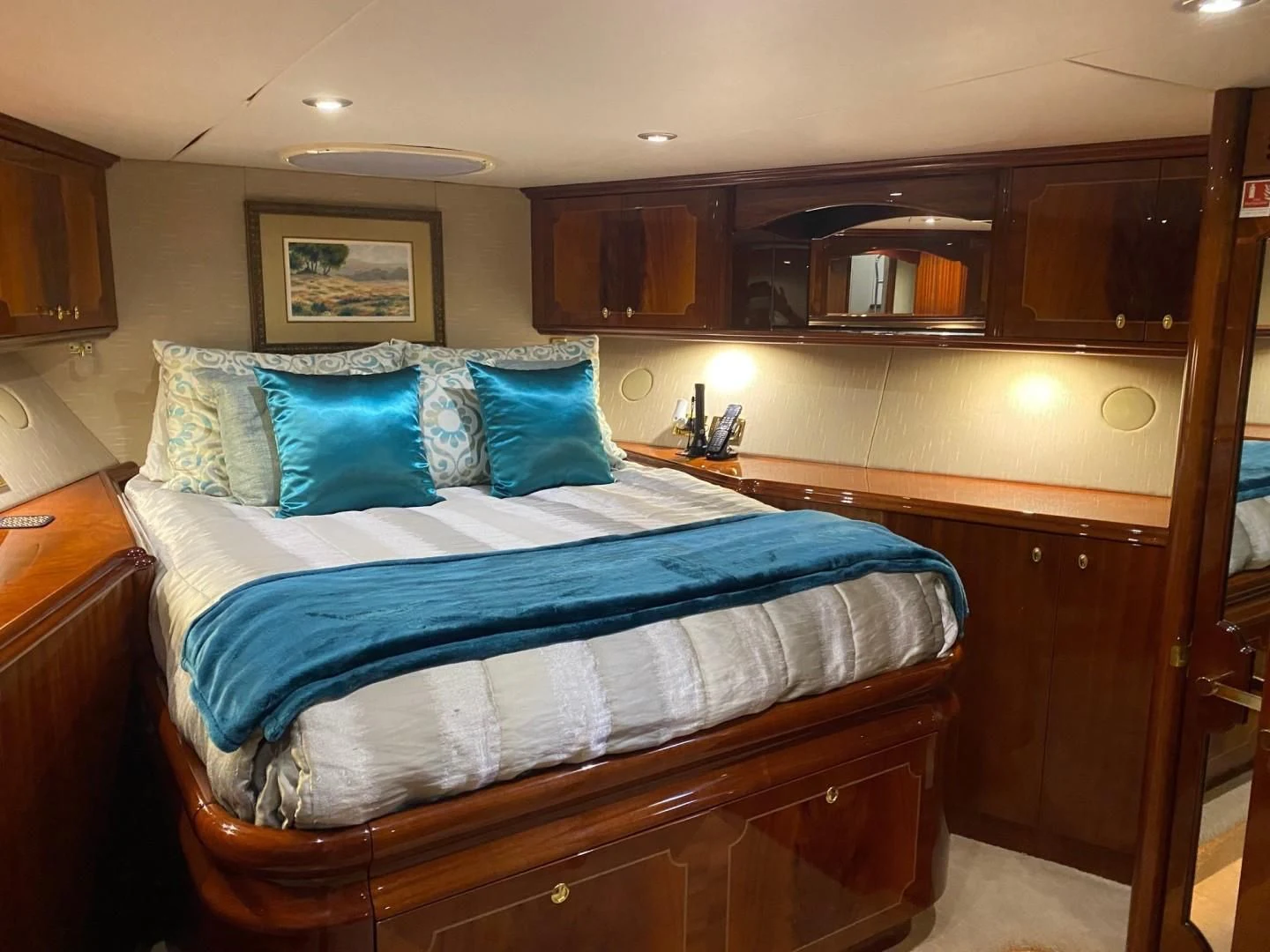 a bed with blue sheets aboard CENTER RING Yacht for Sale