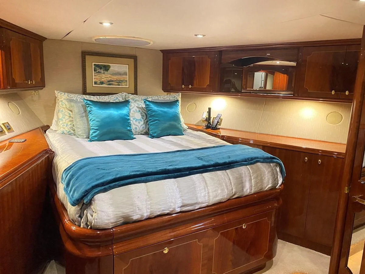 a bed with blue sheets aboard CENTER RING Yacht for Sale