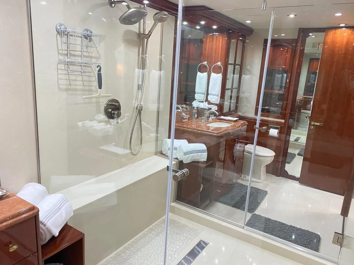 a bathroom with a glass shower aboard CENTER RING Yacht for Sale
