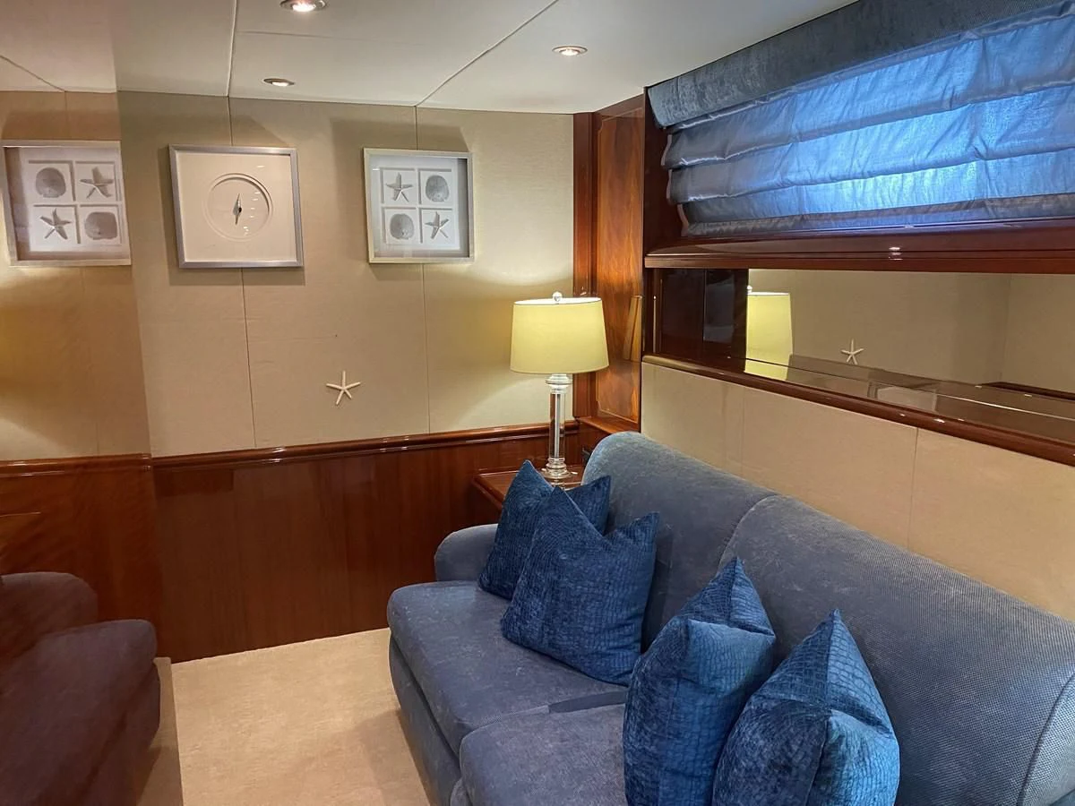a living room with a piano aboard CENTER RING Yacht for Sale