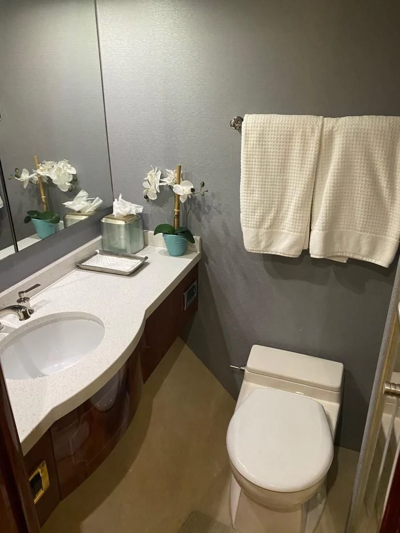 a bathroom with a toilet and sink aboard CENTER RING Yacht for Sale