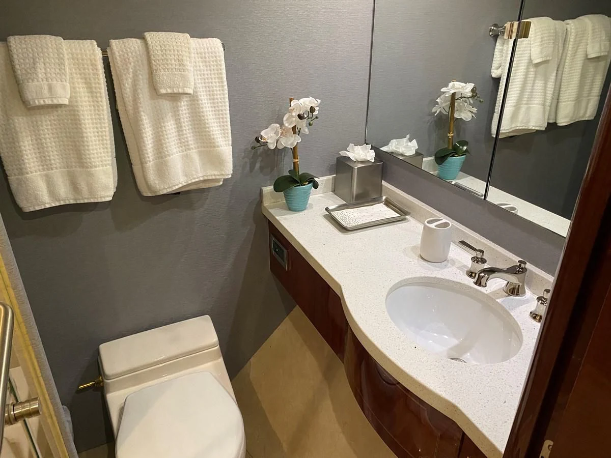 a bathroom with a sink and towels aboard CENTER RING Yacht for Sale