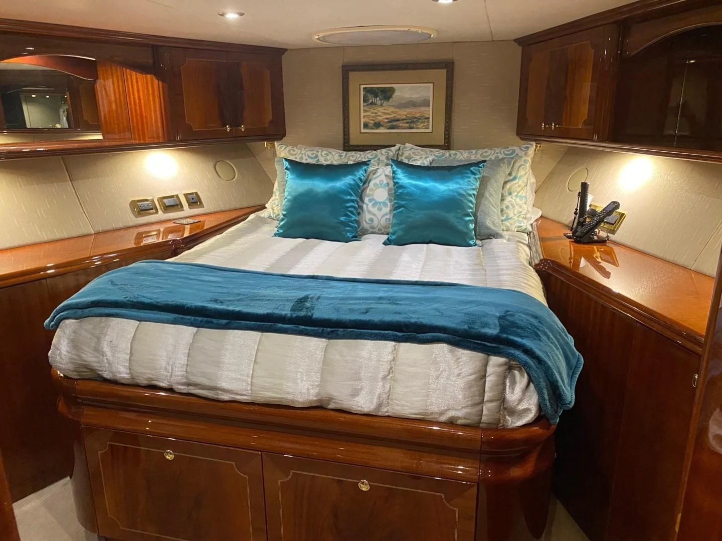 a bedroom with a bed and cabinets aboard CENTER RING Yacht for Sale