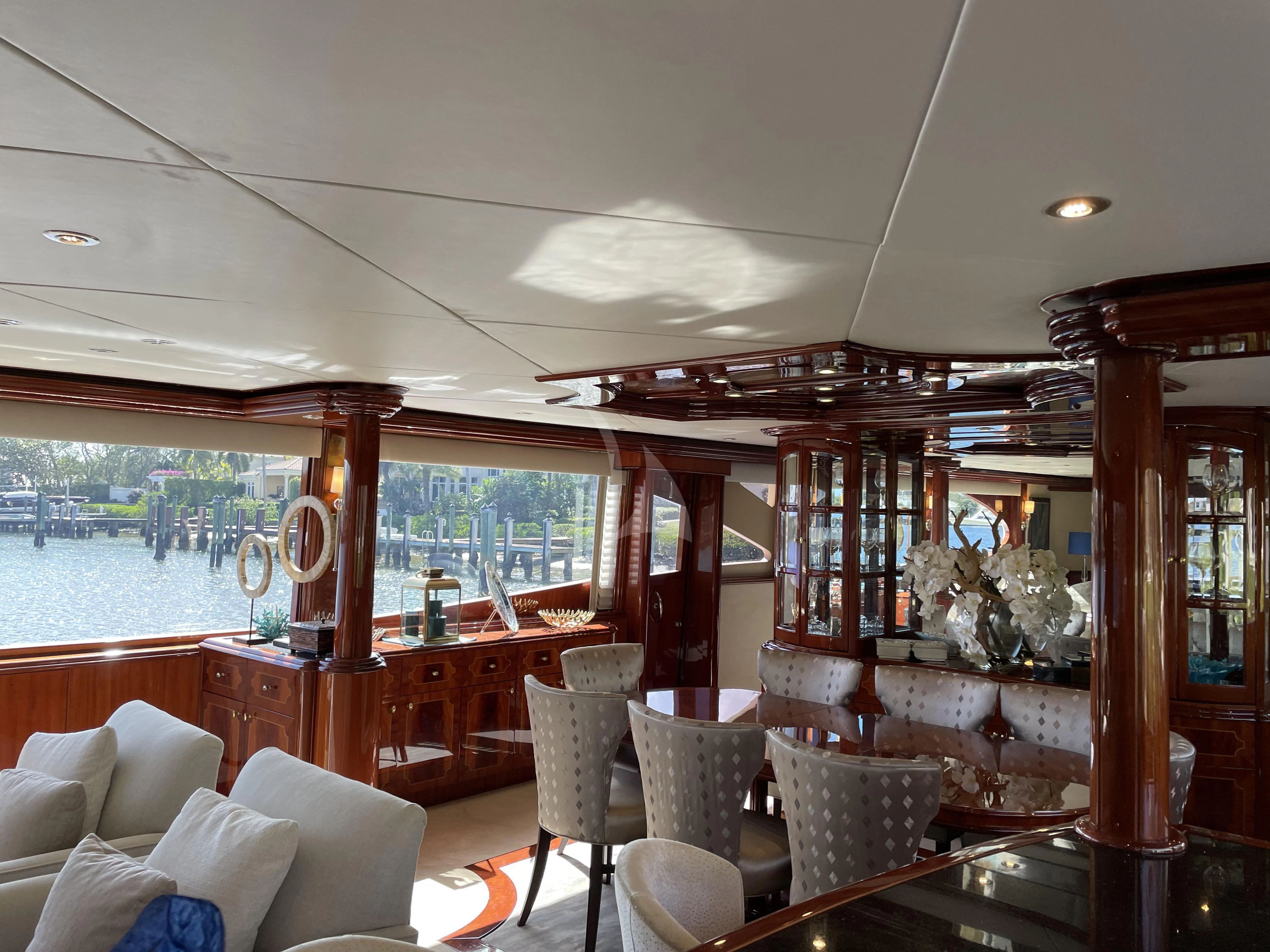 a room with a large window and a table with chairs and a large window aboard CENTER RING Yacht for Sale