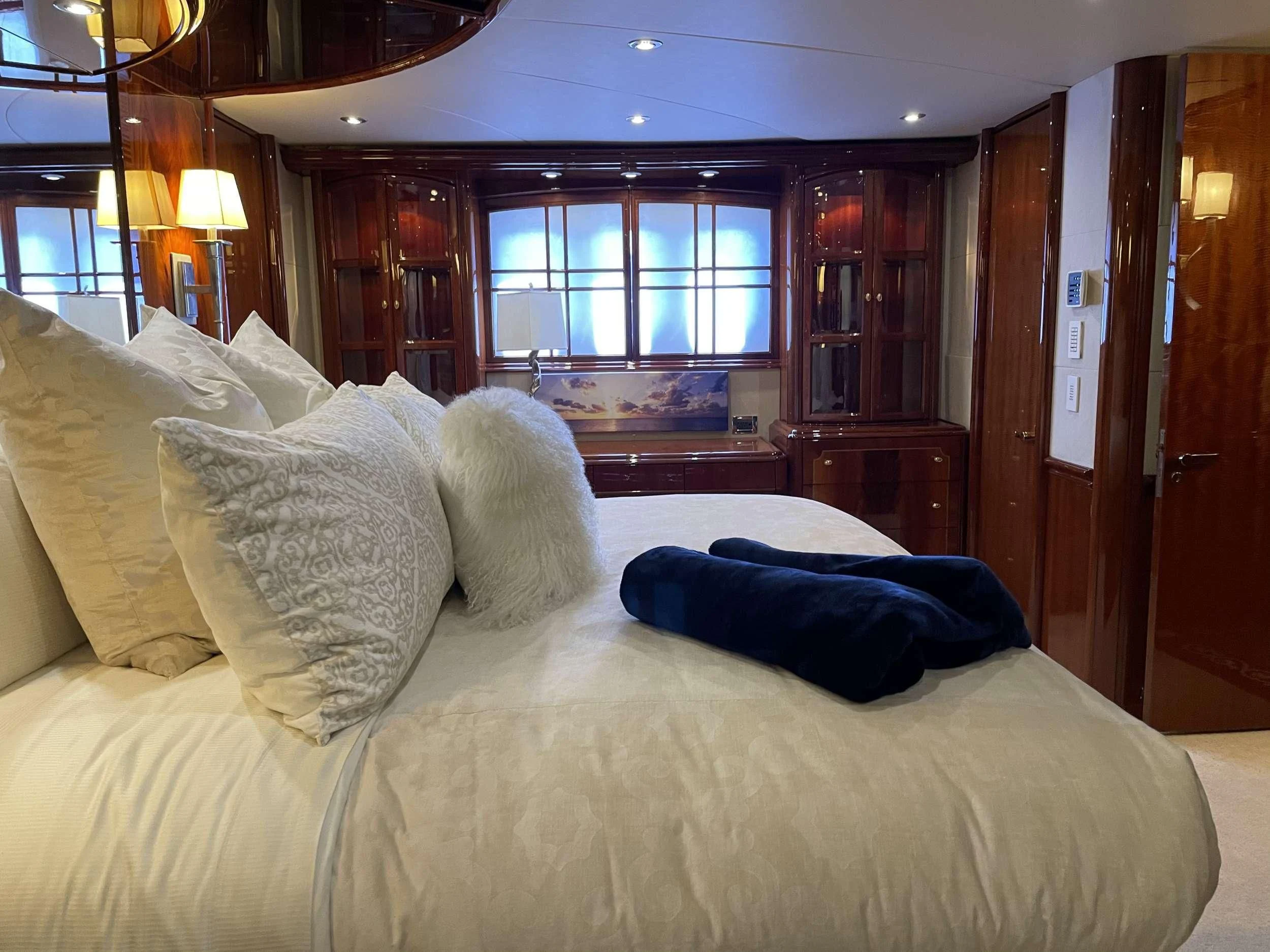 a bed with pillows aboard CENTER RING Yacht for Sale