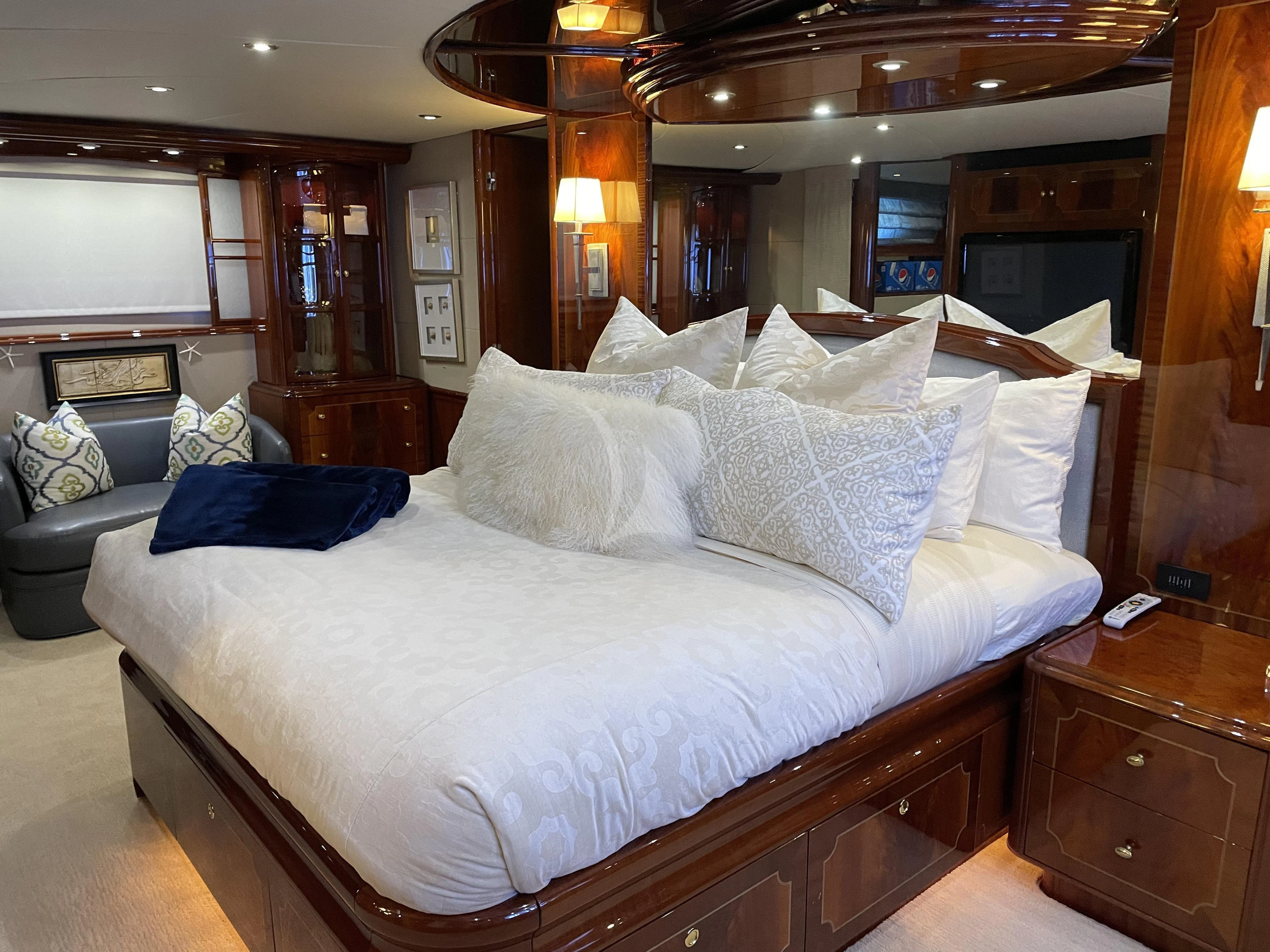 a bed with white sheets aboard CENTER RING Yacht for Sale