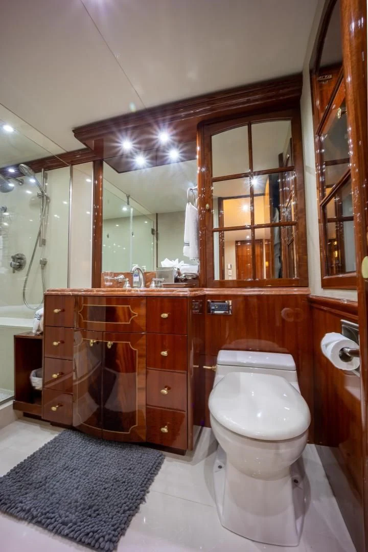 a bathroom with a toilet and a sink aboard CENTER RING Yacht for Sale