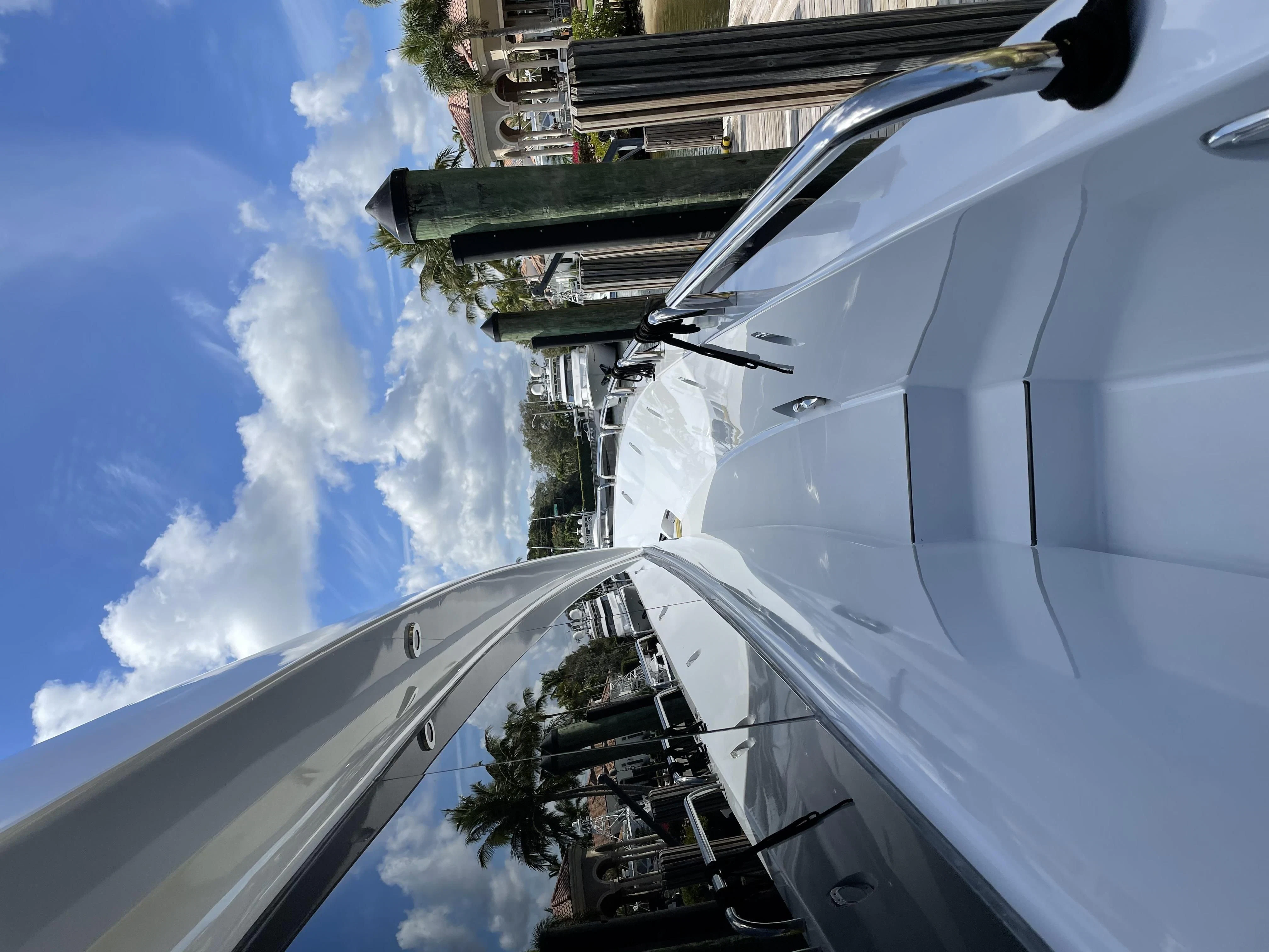 a white boat with smoke coming out of it aboard CENTER RING Yacht for Sale