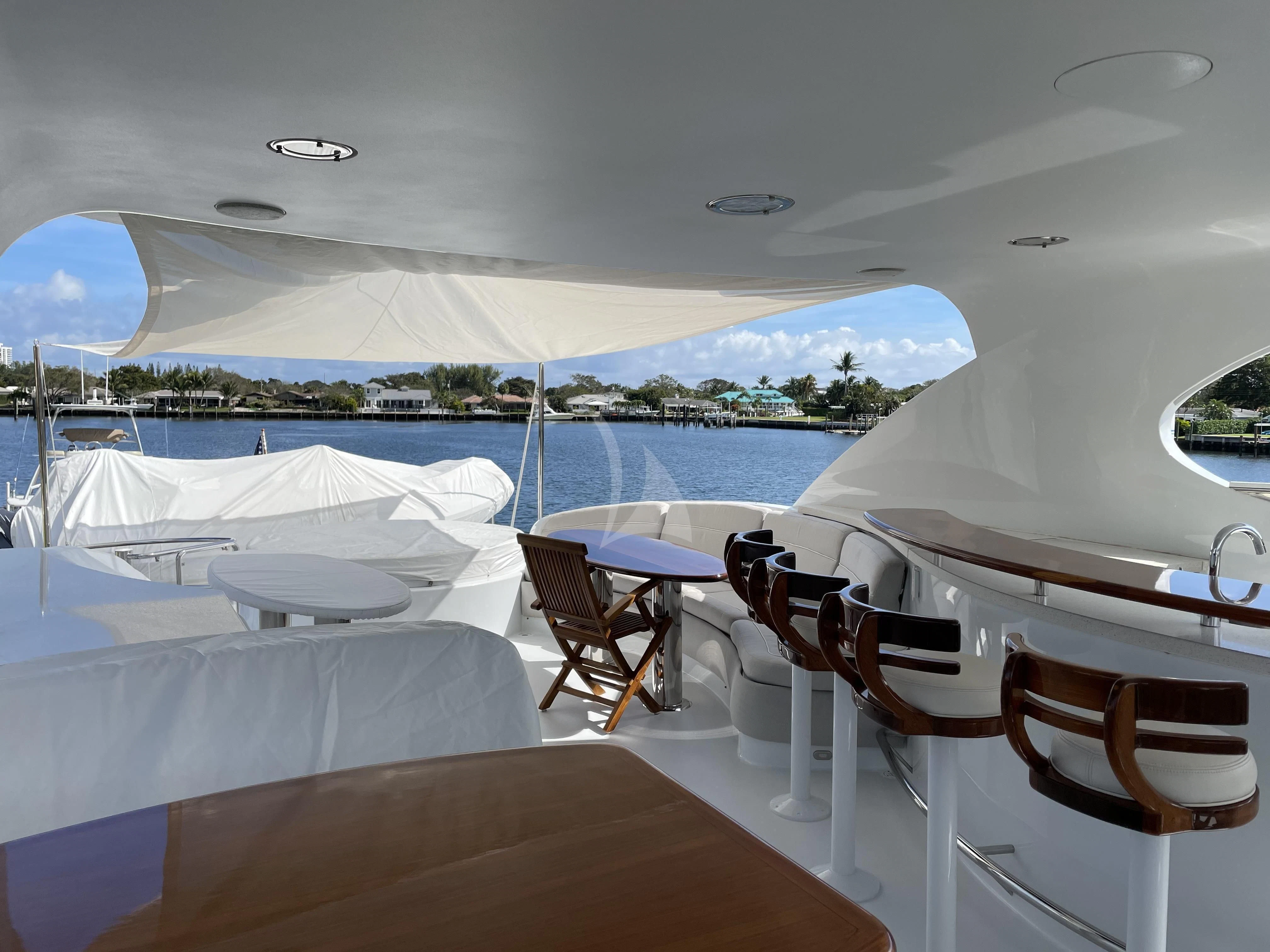 a room with a table chairs and a large body of water aboard CENTER RING Yacht for Sale