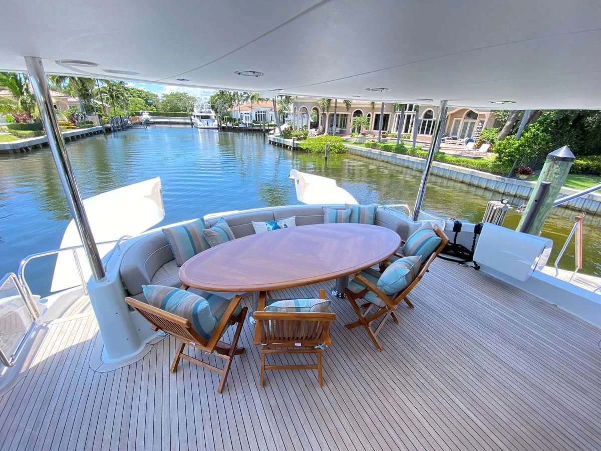 a table and chairs on a deck aboard CENTER RING Yacht for Sale