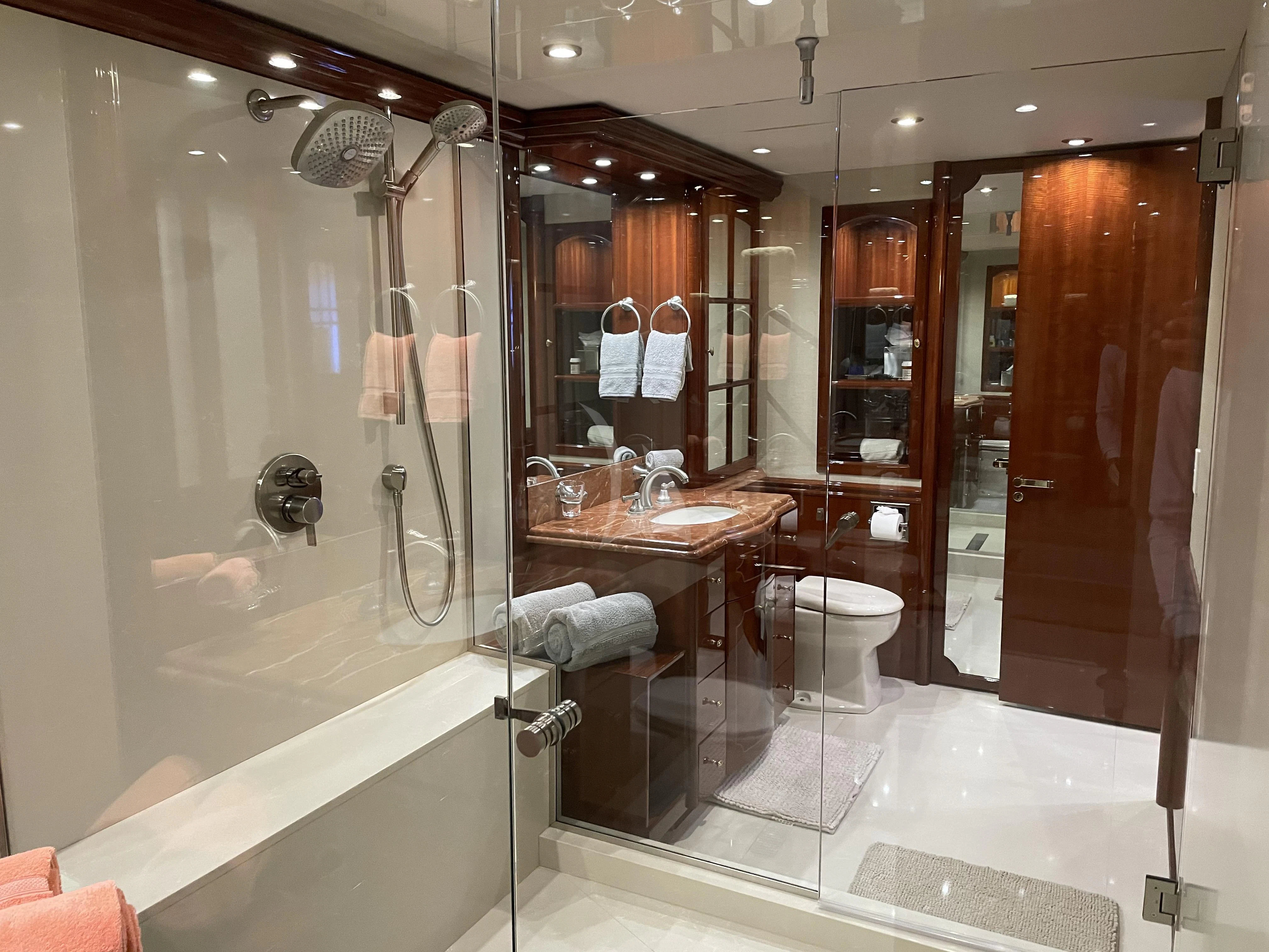 a bathroom with a glass shower aboard CENTER RING Yacht for Sale