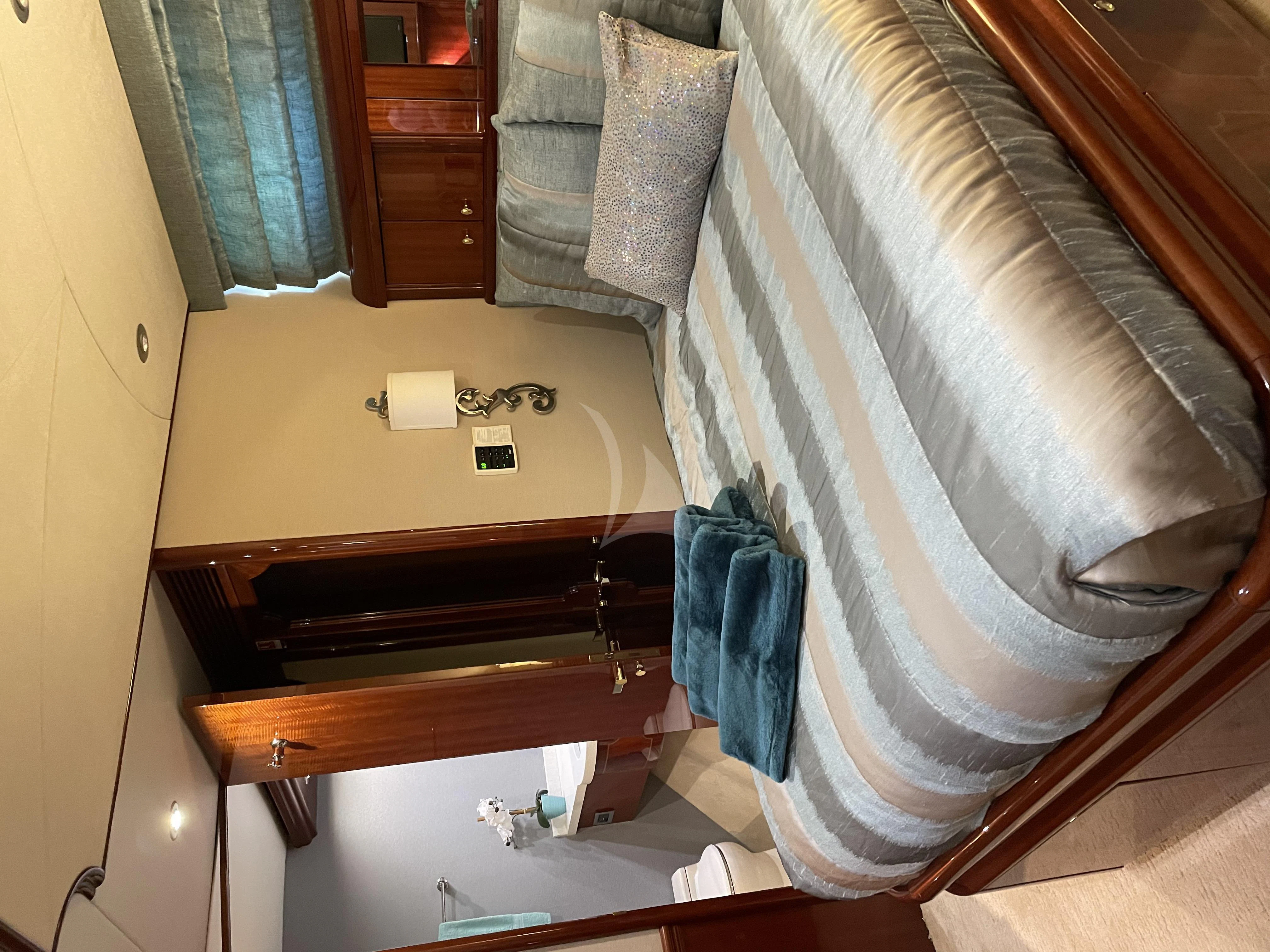 a room with a bed and a chair aboard CENTER RING Yacht for Sale