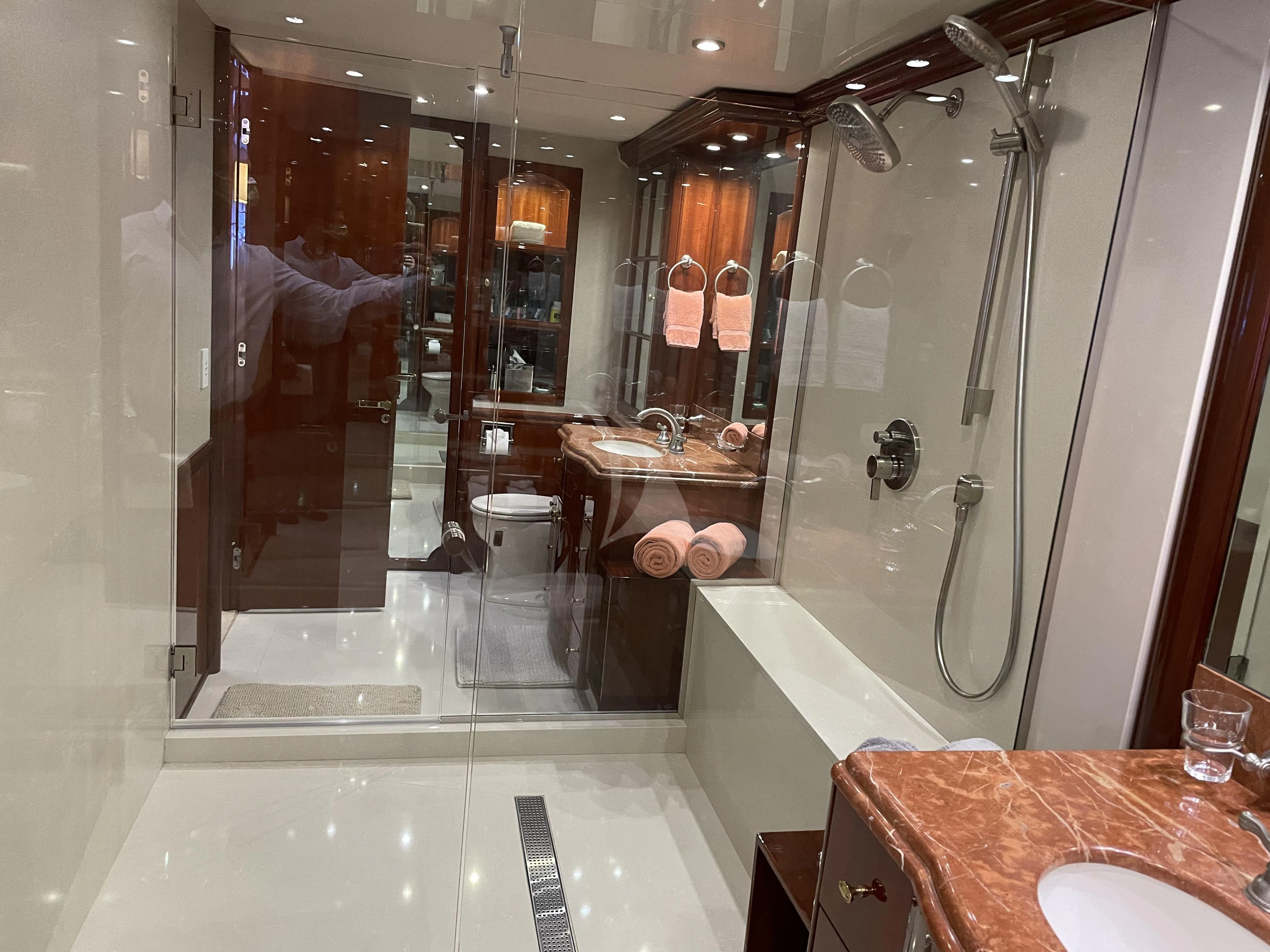a bathroom with a glass shower aboard CENTER RING Yacht for Sale