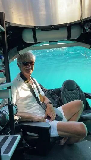 a person sitting in a cockpit aboard MIAMAA Yacht for Sale