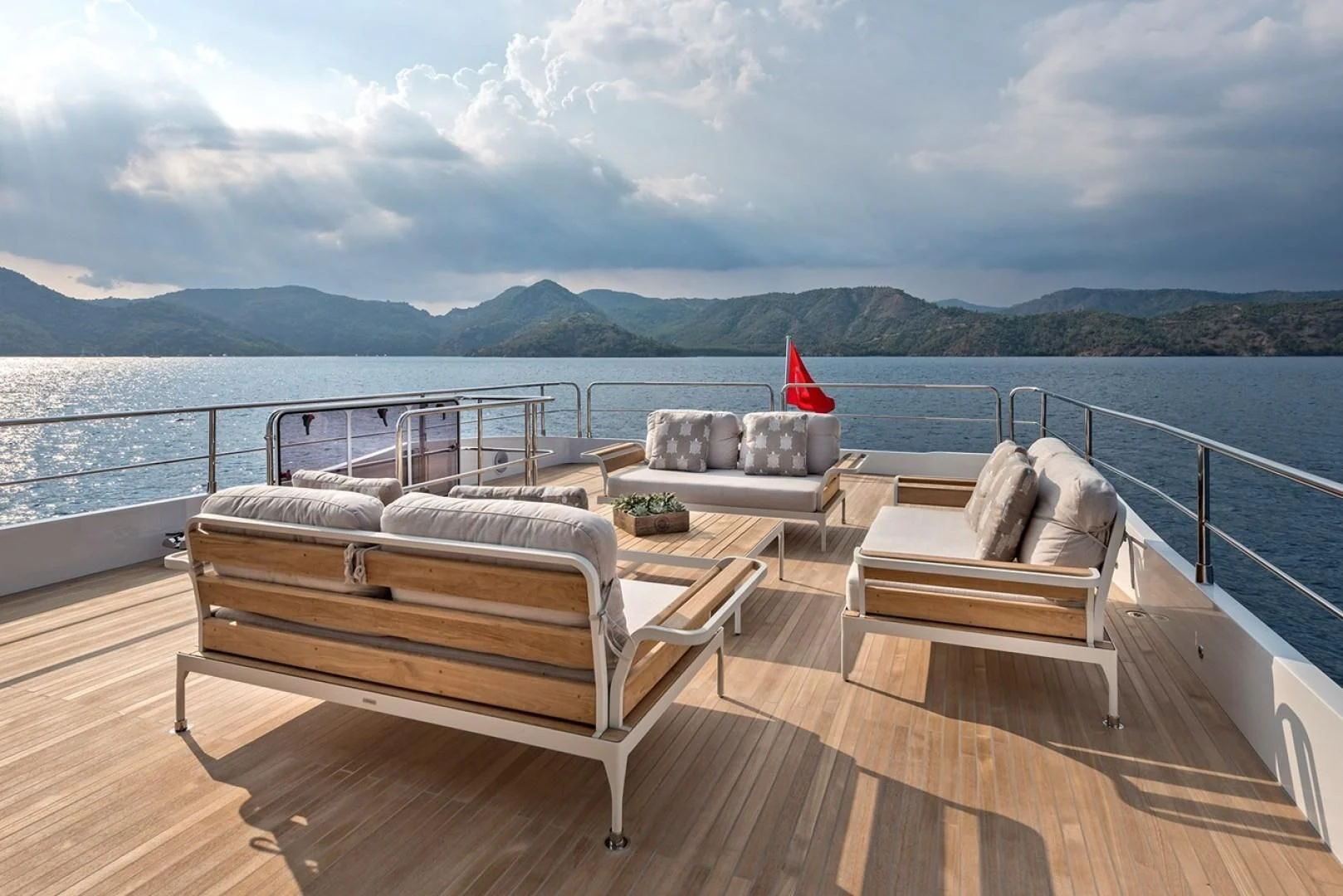 a deck with a view of a body of water and mountains in the background aboard NUMARINE 26XP/24 Yacht for Sale