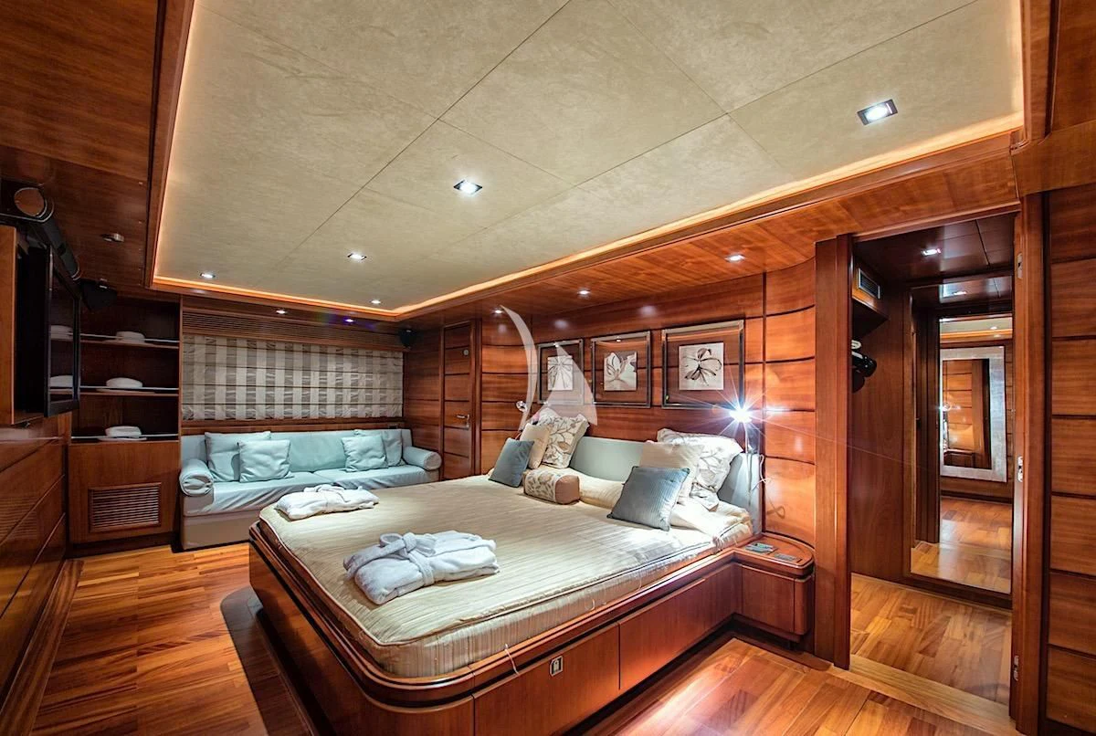 a bedroom with a bed and a mirror aboard ANNE MARIE Yacht for Sale