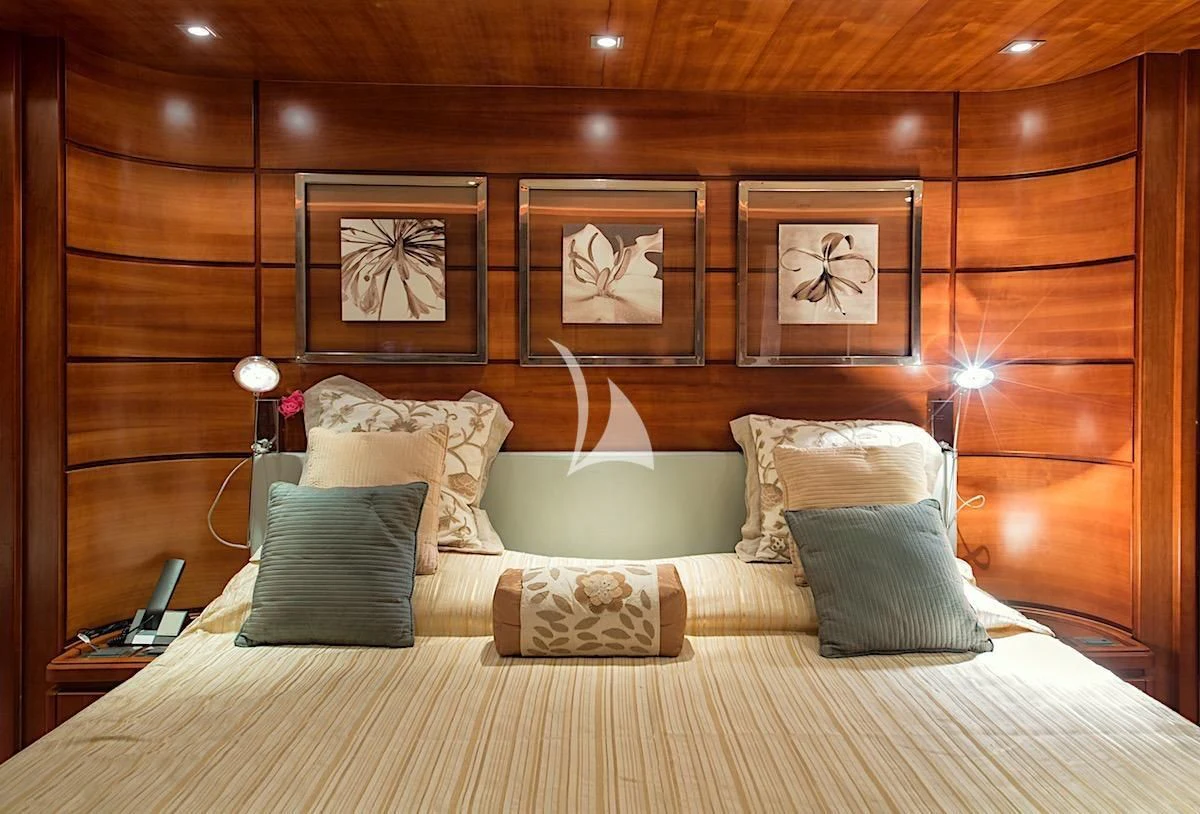 a bed with pillows and a phone aboard ANNE MARIE Yacht for Sale