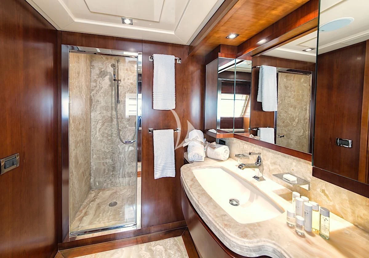 a bathroom with a sink and a shower unit aboard ANNE MARIE Yacht for Sale