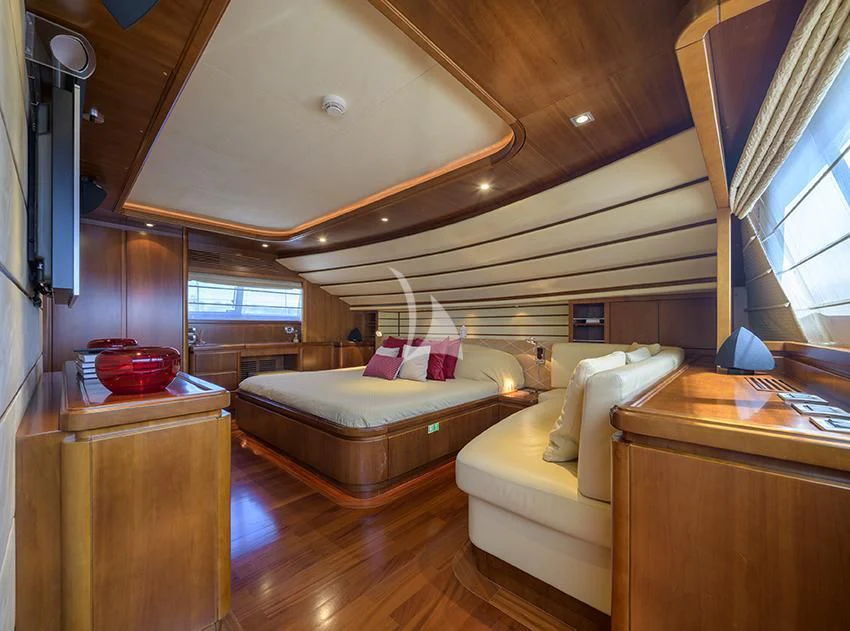 a room with a bed and a table aboard ANNE MARIE Yacht for Sale