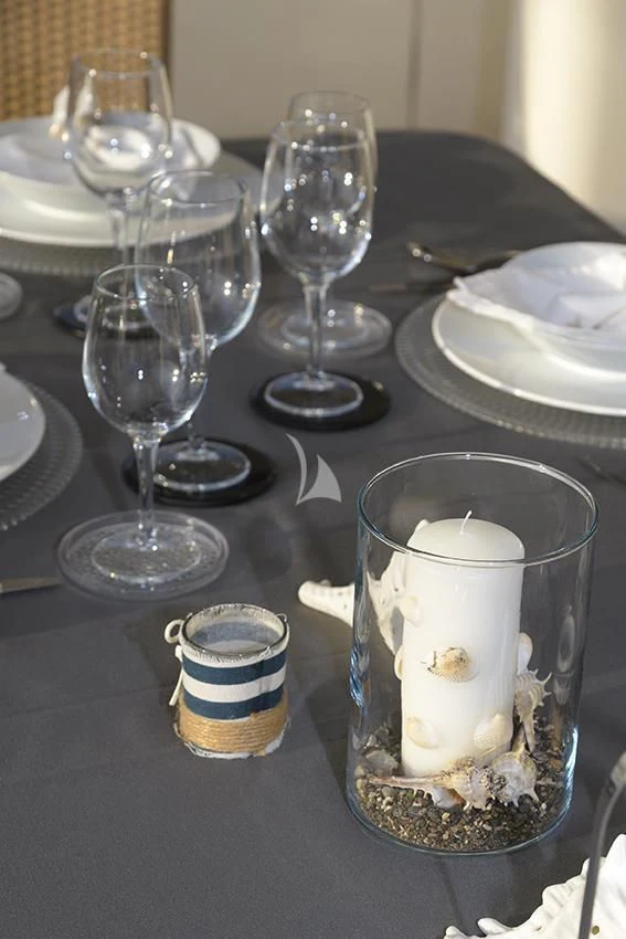 a table with glasses and plates aboard ANNE MARIE Yacht for Sale