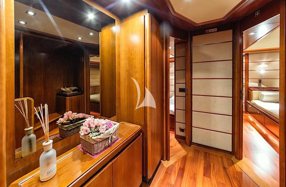 a room with a wood door and a table with flowers in it aboard ANNE MARIE Yacht for Sale