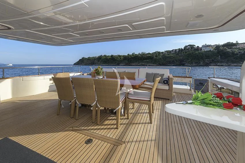a table and chairs on a deck aboard ANNE MARIE Yacht for Sale