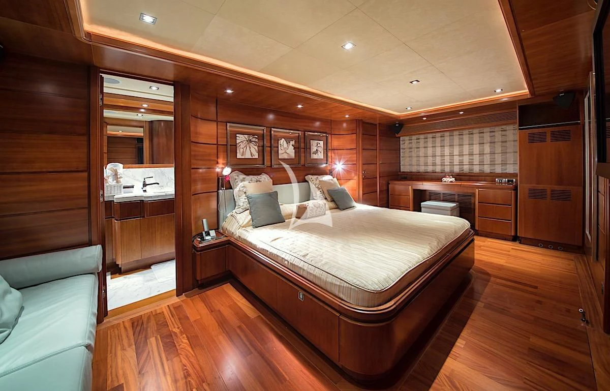 a bedroom with a bed and a couch aboard ANNE MARIE Yacht for Sale