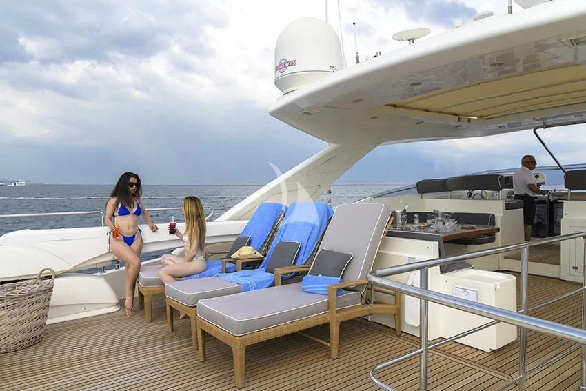 a person standing on a deck looking at a plane aboard ANNE MARIE Yacht for Sale