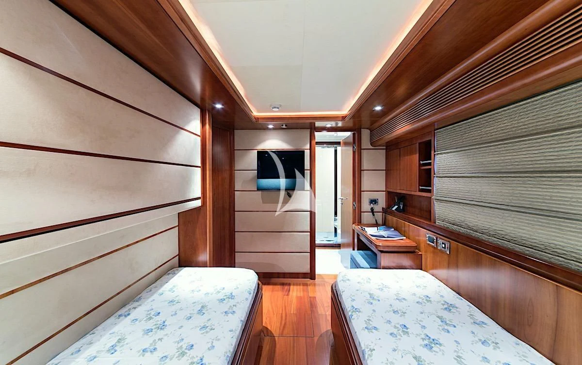 a room with a bed and a chair aboard ANNE MARIE Yacht for Sale