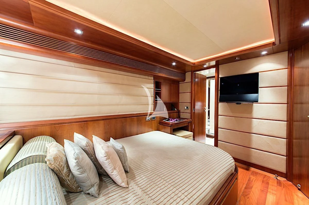 a room with a bed and a television aboard ANNE MARIE Yacht for Sale
