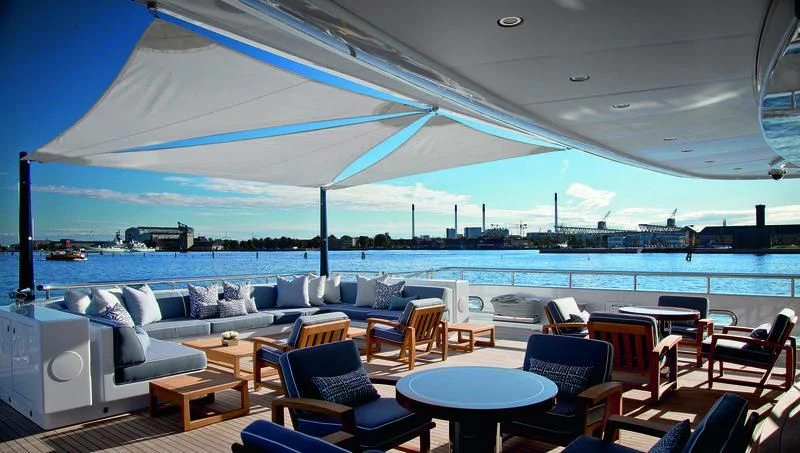 a large lounge area with a large body of water and a large blue sky aboard ODESSA II Yacht for Sale