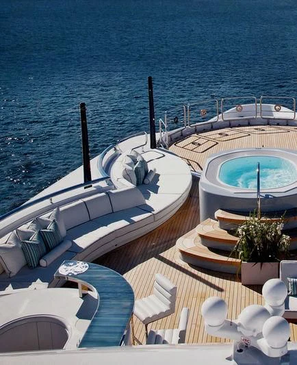 a deck with a pool and a boat on it aboard ODESSA II Yacht for Sale