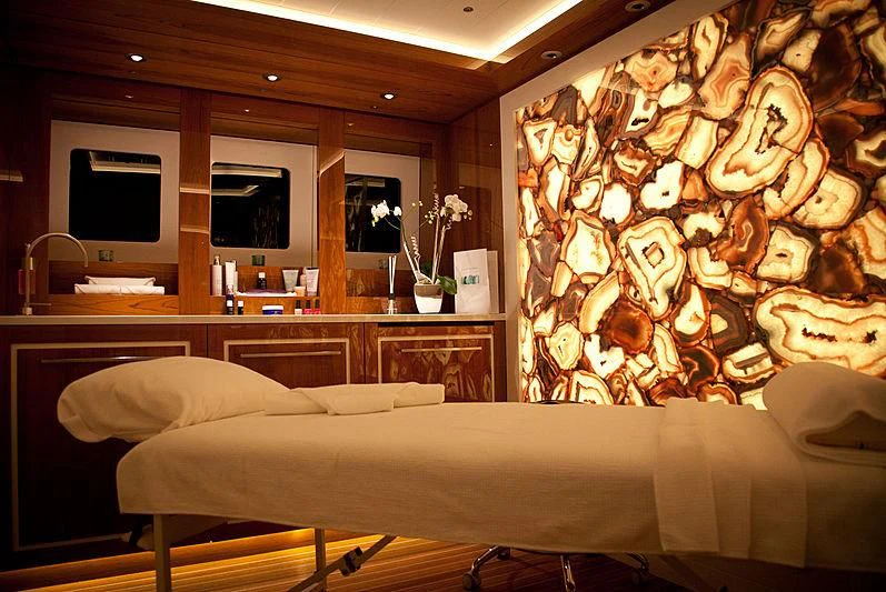 a room with a bed and a tv on the wall aboard ODESSA II Yacht for Sale