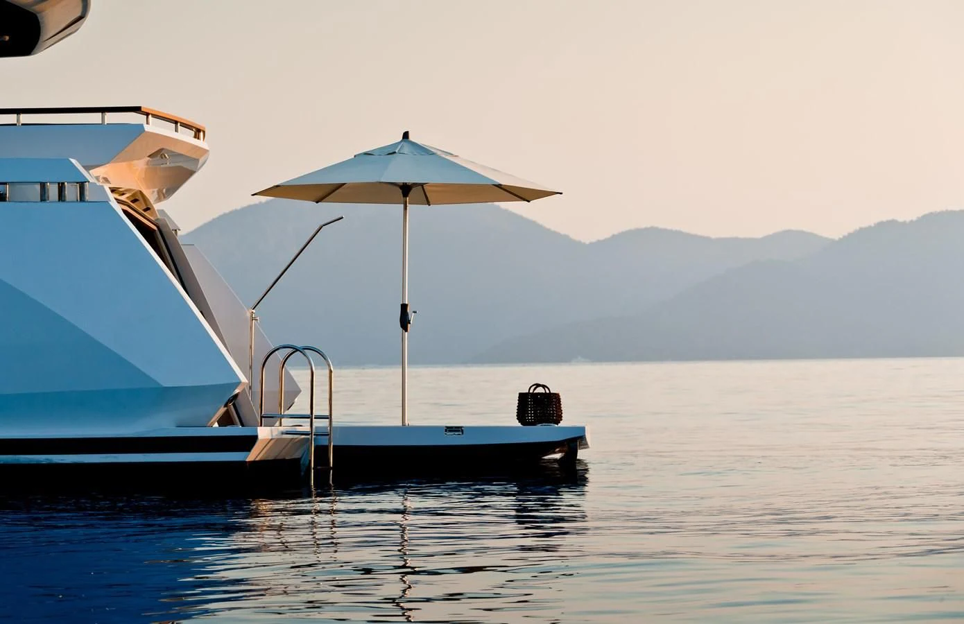 a boat with an umbrella on the water aboard TUCCINI Yacht for Sale
