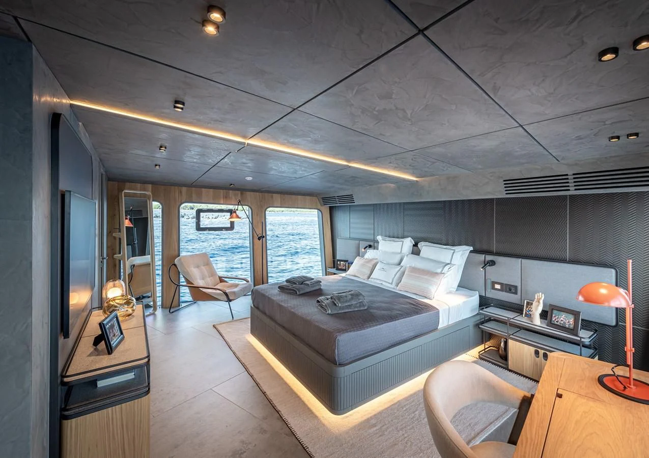 a bedroom with a bed and a desk aboard TUCCINI Yacht for Sale