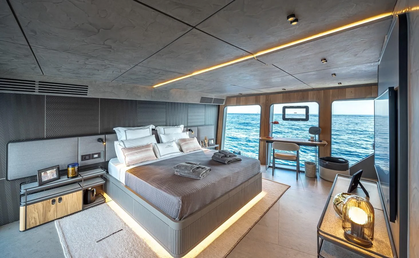 a room with a bed and a fireplace aboard TUCCINI Yacht for Sale