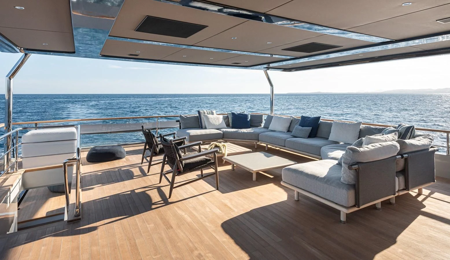 a large living room with a large balcony overlooking the ocean aboard TUCCINI Yacht for Sale