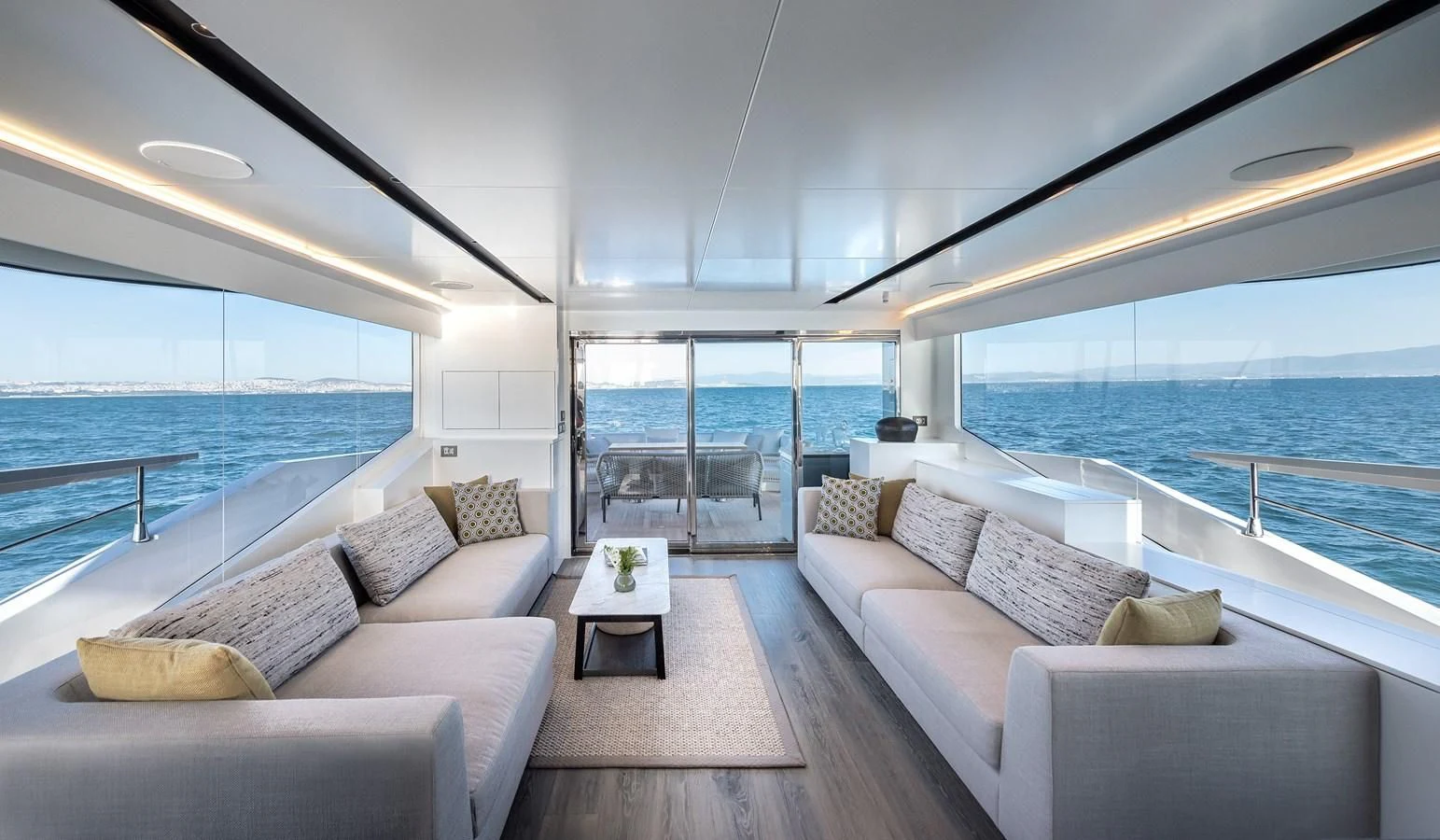 a living room with a large balcony aboard TUCCINI Yacht for Sale