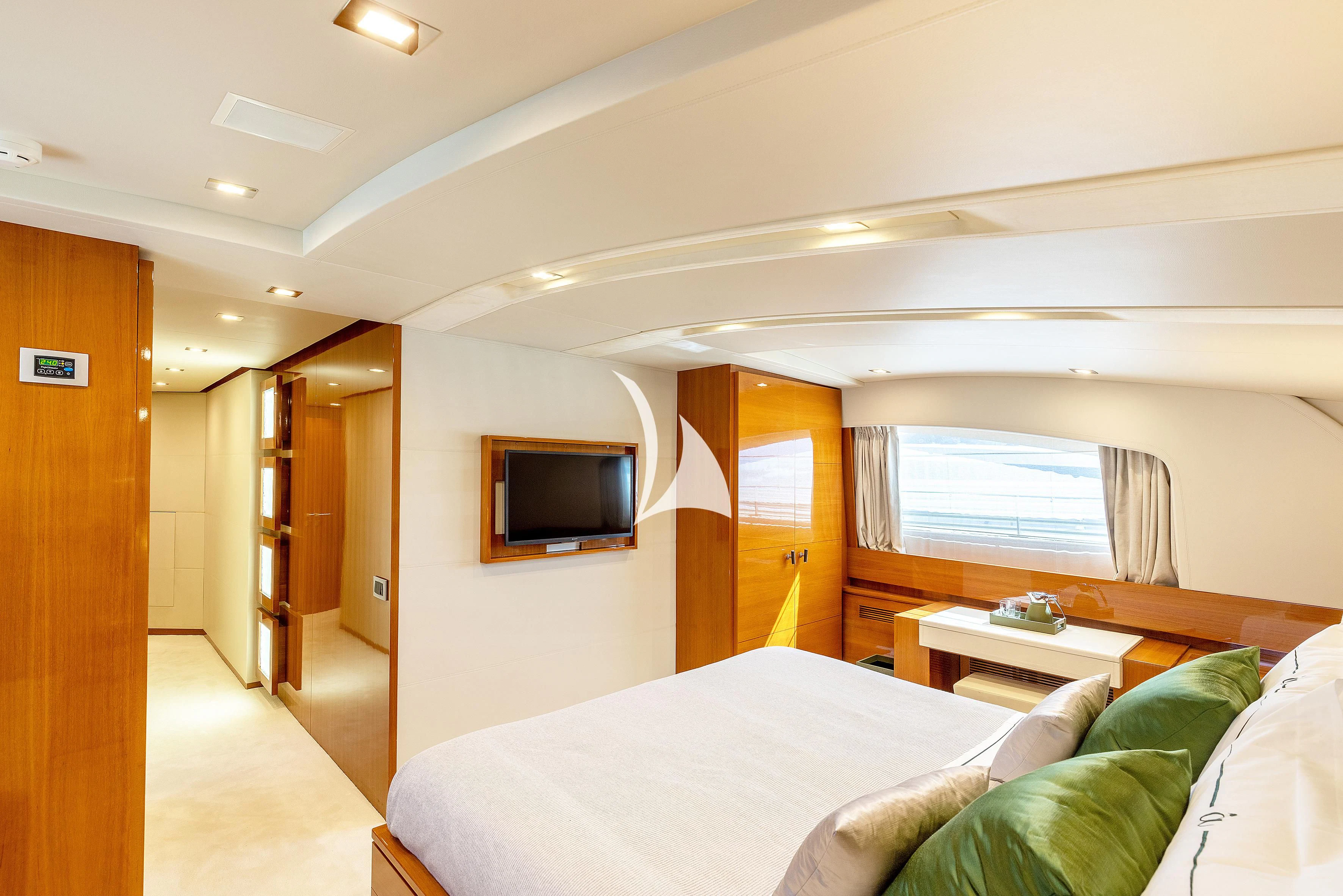 a hotel room with a bed and tv aboard APMONIA Yacht for Sale