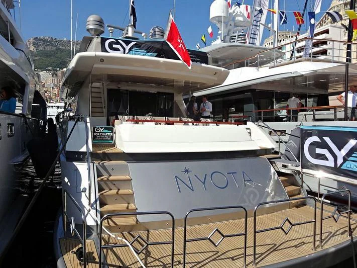 a boat docked at a pier aboard APMONIA Yacht for Sale