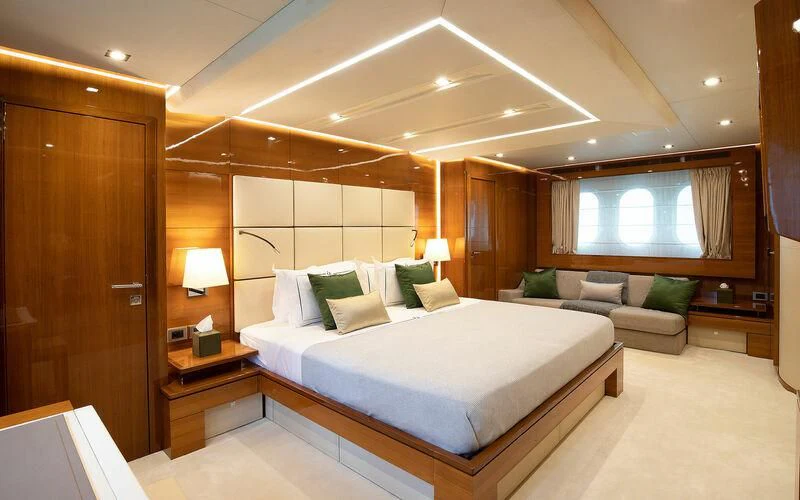 a hotel room with a bed and a couch aboard APMONIA Yacht for Sale