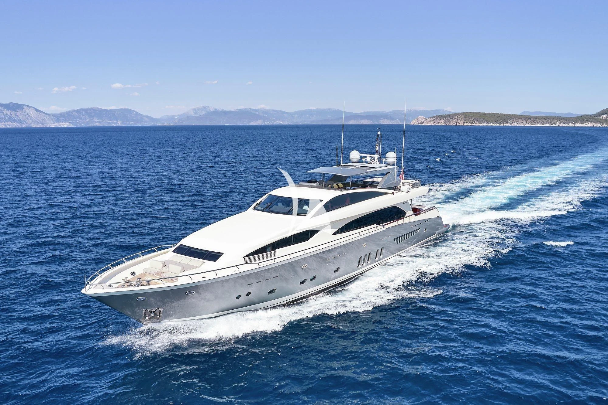 a white yacht on the water aboard APMONIA Yacht for Sale